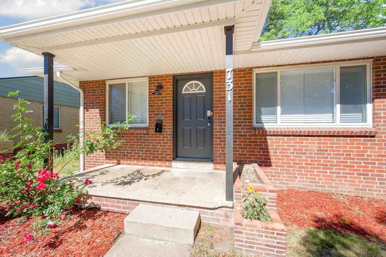 Classic brick Montclair home with covered patio & fenced yard