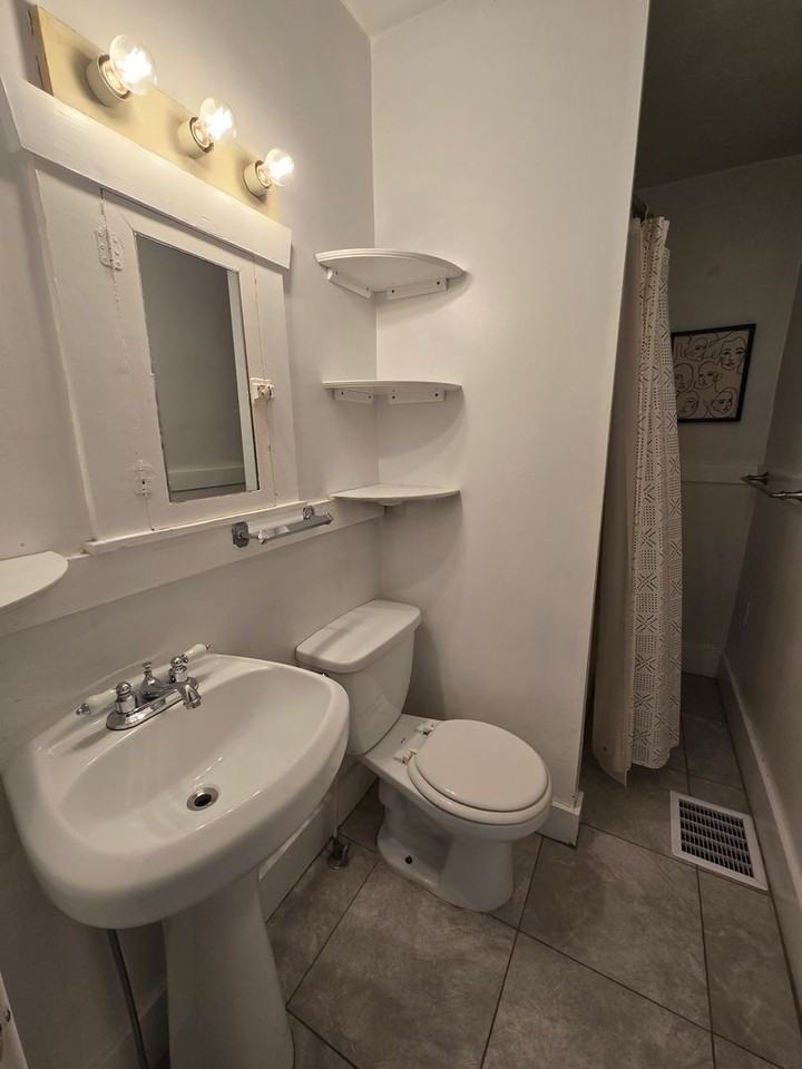 1107 S Ogden St - Photo 6 of 13